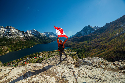 Waterton Lakes National Park and man with Canada flag