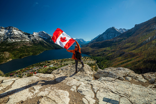 Waterton Lakes National Park and man with Canada flag