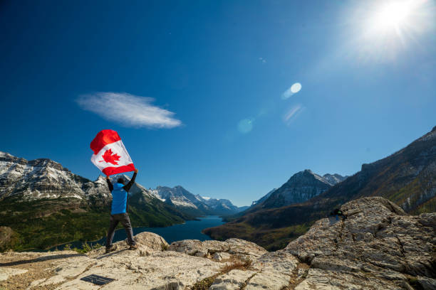 istock Waterton Lakes National Park and man with Canada flag 1278453255