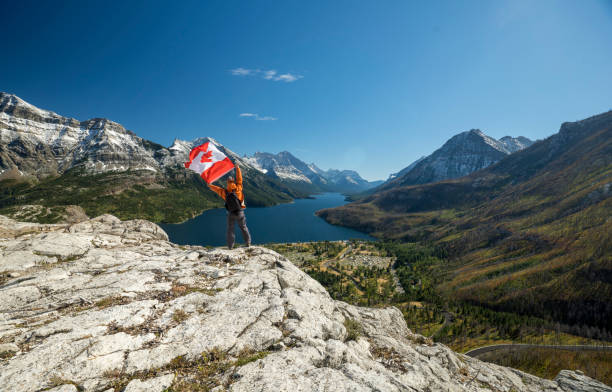 istock Waterton Lakes National Park and man with Canada flag 1278453346