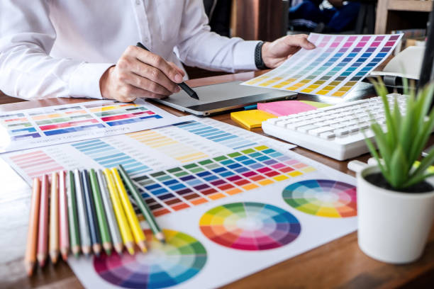 istock Image of male creative graphic designer working on color selection and drawing on graphics tablet at workplace with work tools and accessories 1278454425