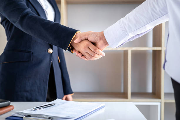 istock Greeting new colleagues, Handshake while job interviewing, Female candidate shaking hands with Interviewer or employer after a job interview, employment and recruitment concept 1278455289
