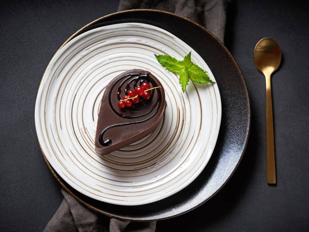 istock Dessert covered with chocolate frosting with red currant and mint 1278457260