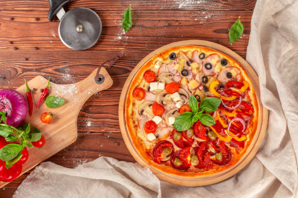 istock Delicious fresh pizza served on wooden table 1278458531