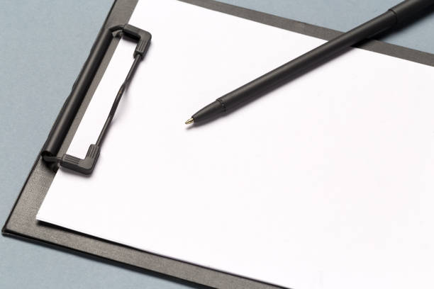 istock Notes clipboard with pen and blank sheets of paper as mock up copy space, top view 1278458986