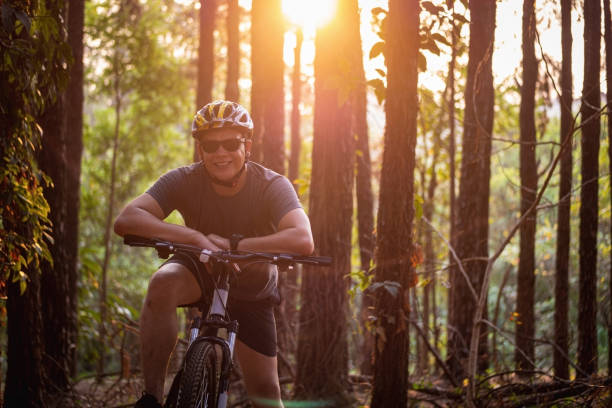 istock Bike rider at a pine trees forest. 1278459868