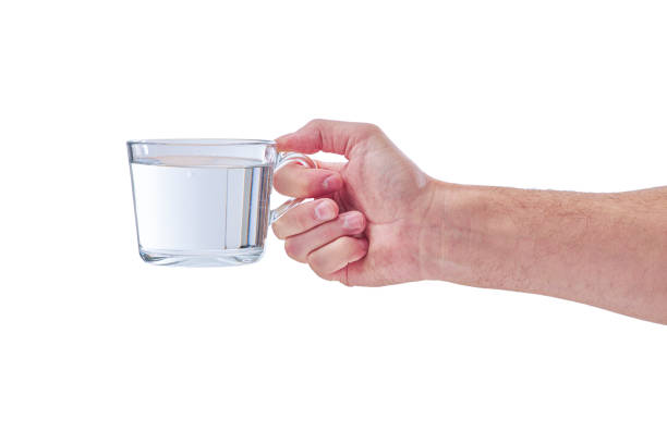 istock Female human hand holding liquid drink water glass 1278459967
