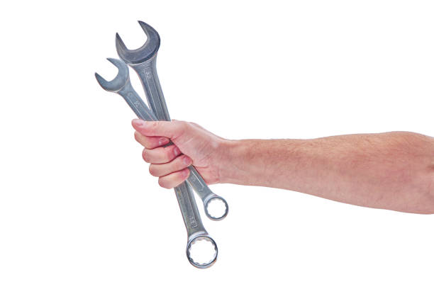 istock Mechanic hand hold spanner tool in hand isolated on white 1278460006