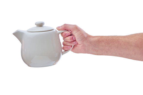 istock male hand holds a white teapot, isolated 1278460013