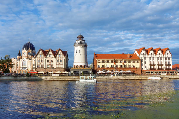 Fish village district with a lighthouse in Kaliningrad city, Russia Fish village district with a lighthouse on the bank of the Staraya Pregolya river in the rays of the setting sun. Kaliningrad, Russia fish village stock pictures, royalty-free photos & images