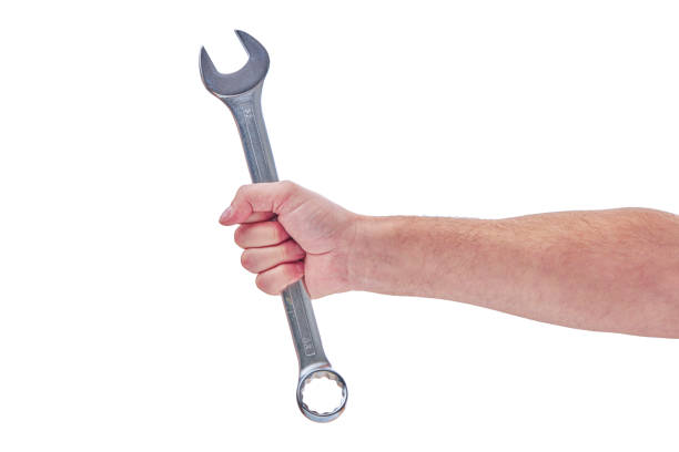 istock Mechanic hand hold spanner tool in hand isolated on white 1278460236