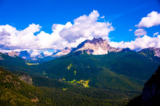 istock pine forests and pink dolomites among white clouds 1278461264