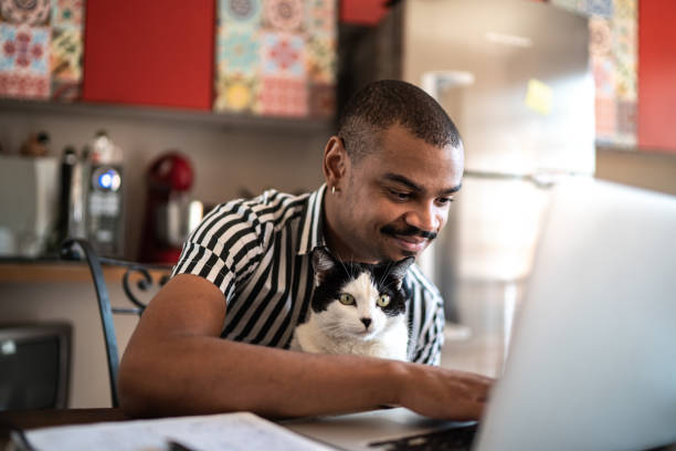 Man working at home with his domestic cat