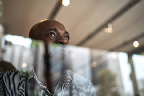 istock Man looking through window on his small business 1278467107