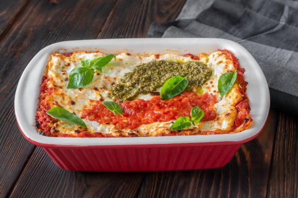 istock Lasagne topped with tomato sauce and pesto 1278468154