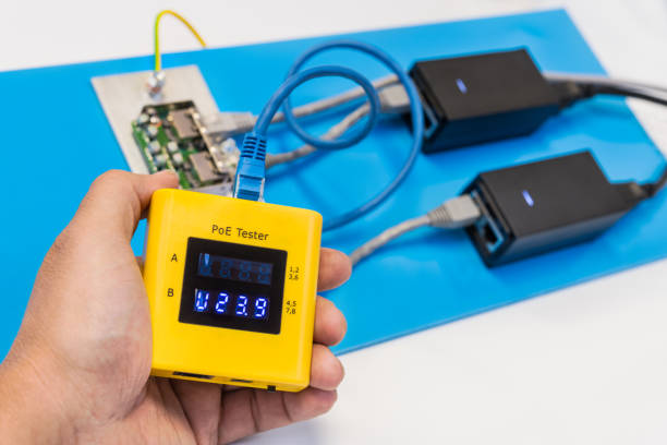 istock Measurement of power over ethernet supply voltage by data cable tester in technician hand. PoE 1278468567
