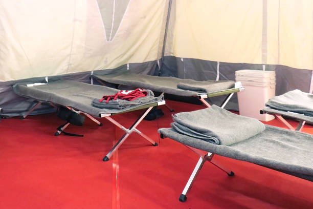 Temporary hospital medical accommodation Temporary hospital medical accommodation interior with beds and blankets for patients during pandemic emergency shelter photos stock pictures, royalty-free photos & images