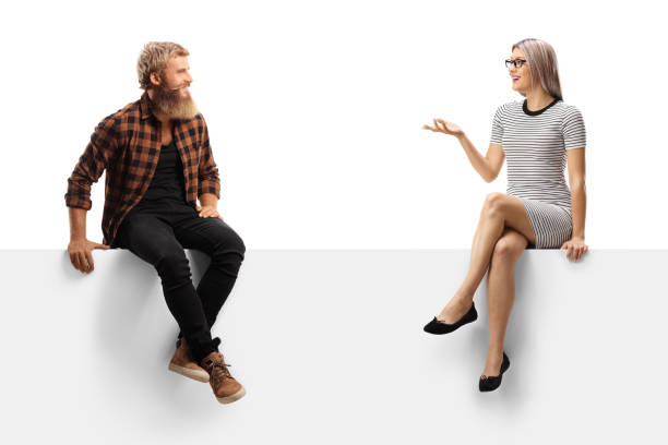 istock Bearded guy sitting on a white panel and listening to a young woman talking 1278473691