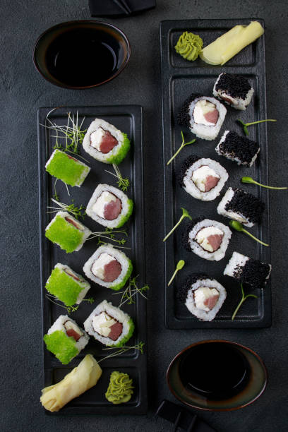 istock Seafood delicatessen sushi rolls set on plates 1278475028