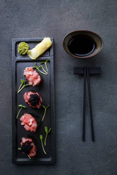 istock Appetizing tuna gunkan sushi set on black plate 1278475032
