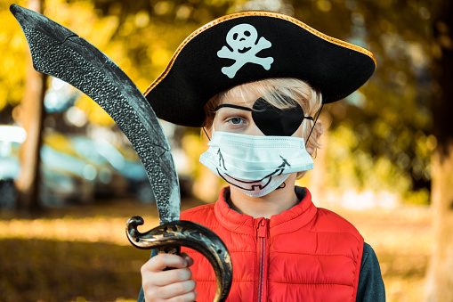 Little pirat wearing facial mask. Halloween theme.