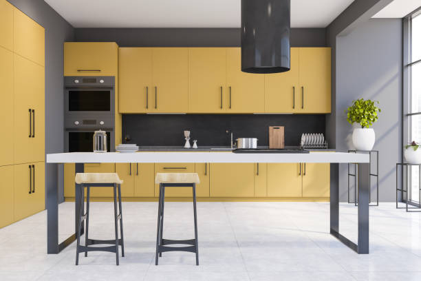 istock Gray and yellow kitchen with bar 1278478824