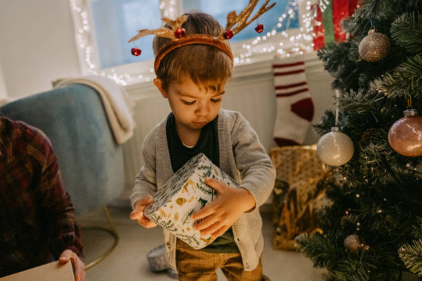istock Little boy opening Christmas presents 1278478870