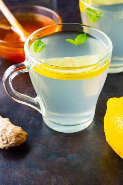istock Ginger tea with lemon on a dark background. Two cups of ginger tea and ingredients for its preparation 1278479363