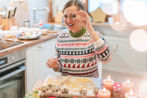istock Woman in the Christmas kitchen posing with cookie cutter 1278480006