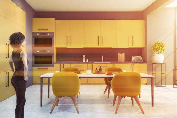 istock woman standing in stylish kitchen with white walls, 1278480176