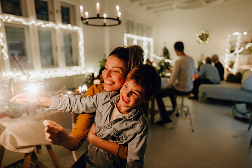 Photo of special moment young mother and her boy had shared, while celebrating Christmas Eve at home with family