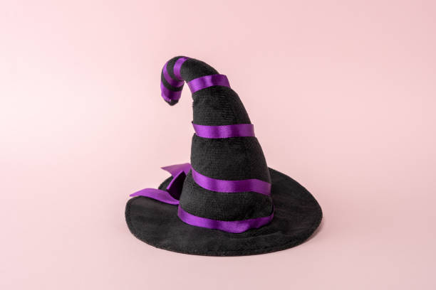 istock Witch hat on a pink background. Minimal Halloween spooky concept. 1278485012