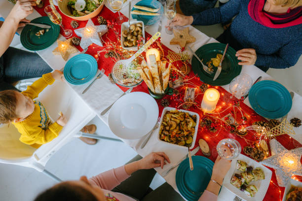 istock Family celebrating December Holidays over dinner 1278485993