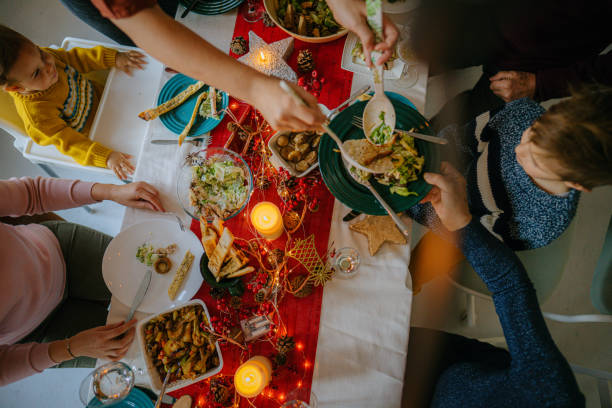 istock Family celebrating December Holidays over dinner 1278486012