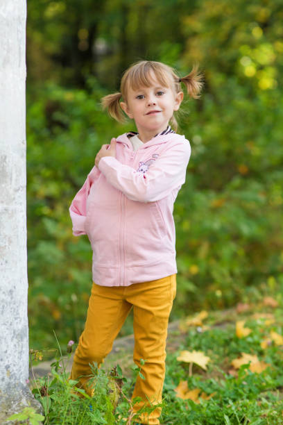 istock A girl with a broken arm stands near a column in an old park on an autumn walk 1278486607