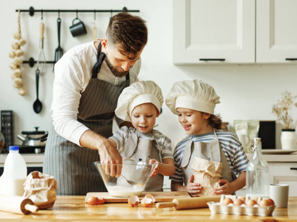 istock Father and kids preparing pastry together 1278488679