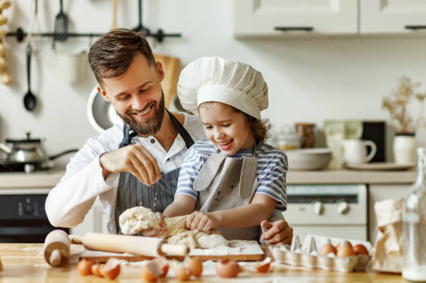 istock Father and daughter making pastry together 1278488724