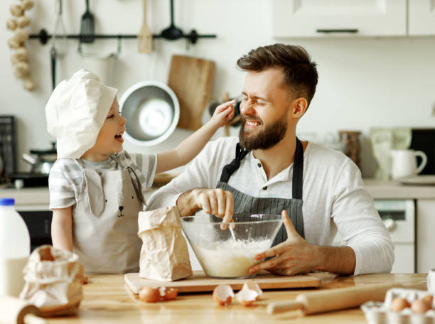 istock Cheerful dad and kid having fun while cooking together 1278488763