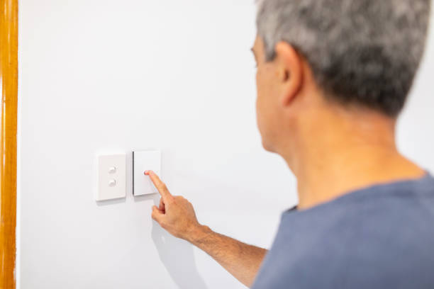 istock Middle Aged Man Using an Air Conditioner Thermostat 1278492056