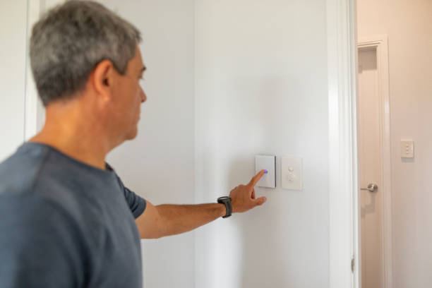 istock Middle Aged Man Using an Air Conditioner Thermostat 1278492059