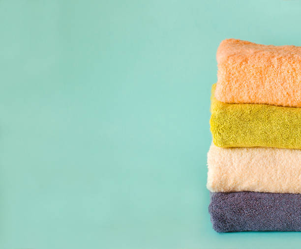 istock Stack of terry towels on a green background. Laundry day. 1278493922