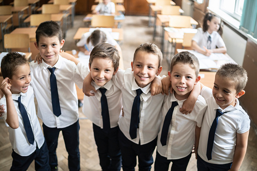 Portrait of a group of young children standing together in the classroom