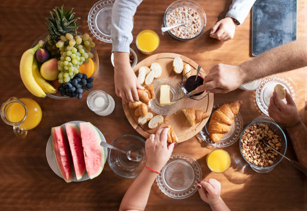 istock Breakfast table, family having healthy breakfast at home, directly from above. 1278494828