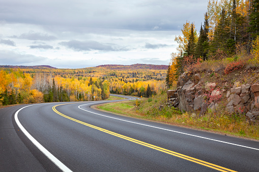 Curving highway and colorful trees in northern Minnesota on a autumn day
