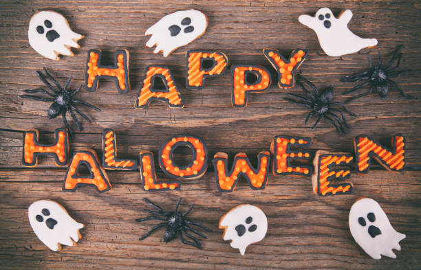 istock Happy Halloween with gingerbread handmade cookies on rustic wooden table 1278497406
