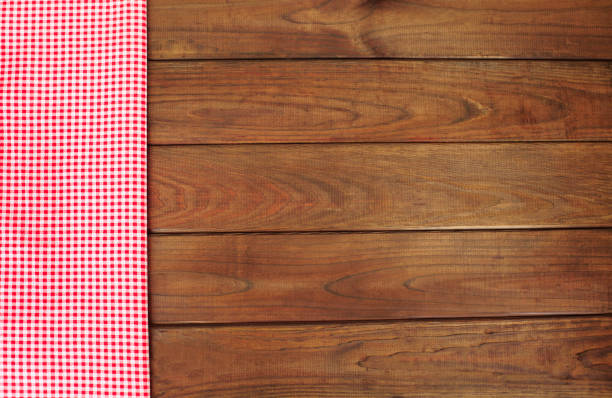 istock Wooden background with red and white checkered fabric border. 1278498130