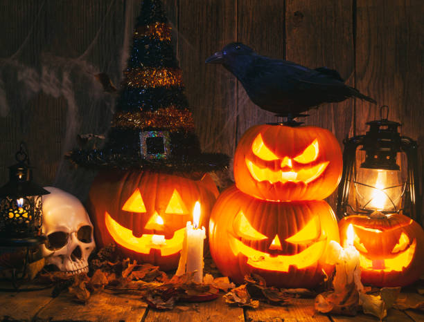 istock Halloween Jack-o-Lantern Pumpkins on rustic wooden background 1278498234