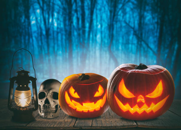 istock Pumpkin Burning In A Spooky Forest At Night - Halloween Background 1278498245