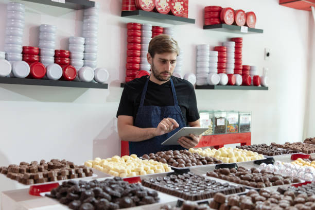 istock Entrepreneur with digital tablet a his chocolate store 1278500325