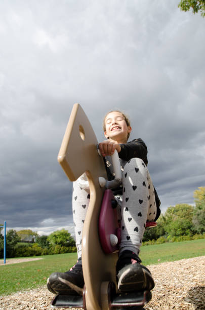 istock Girl playing on a horse swing 1278501091